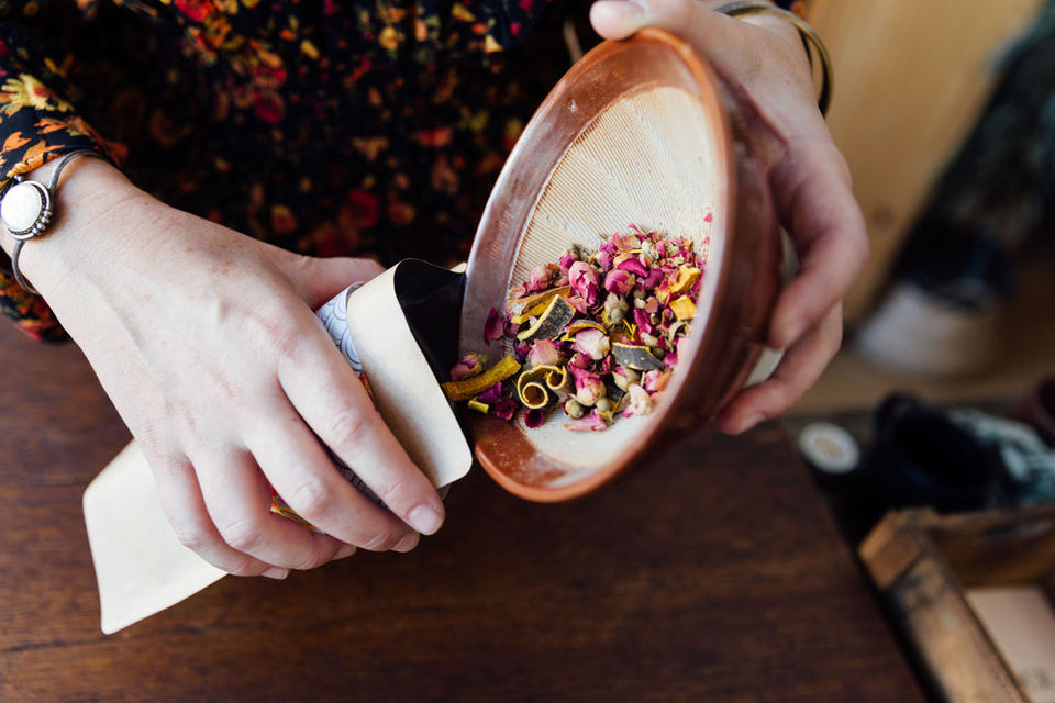 herbs in bowl being poured into packaging - photo by Sarah Deragon